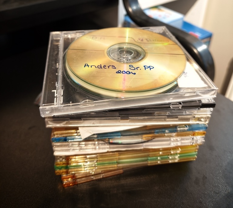 A stack of CDs and DVDs